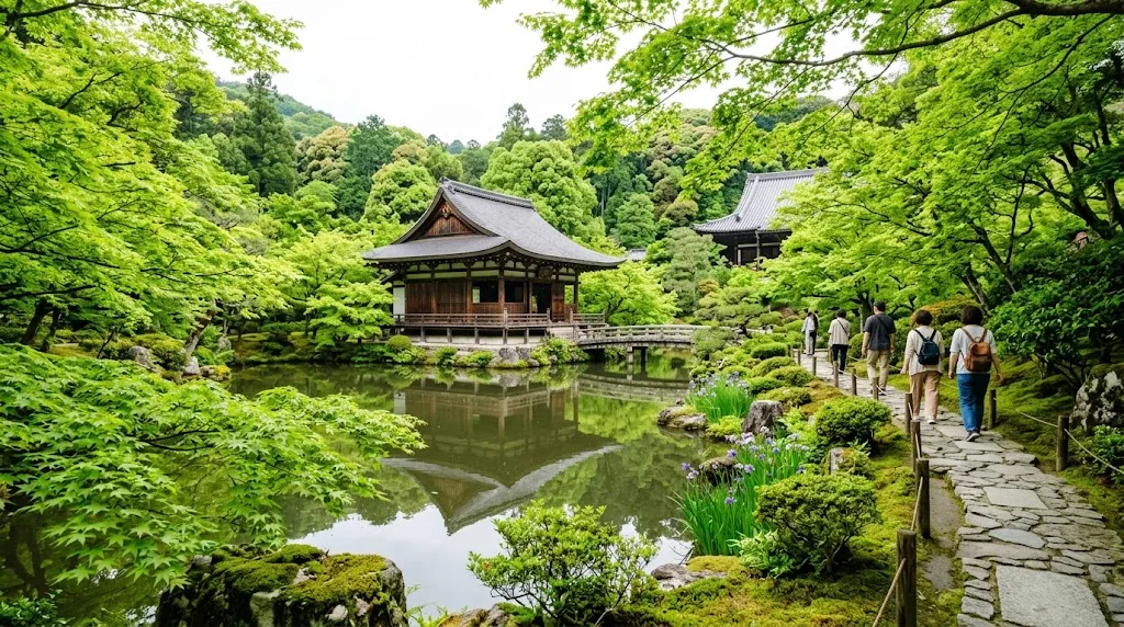 A green Kyoto temple garden with a pond and wooden pavilion in late May